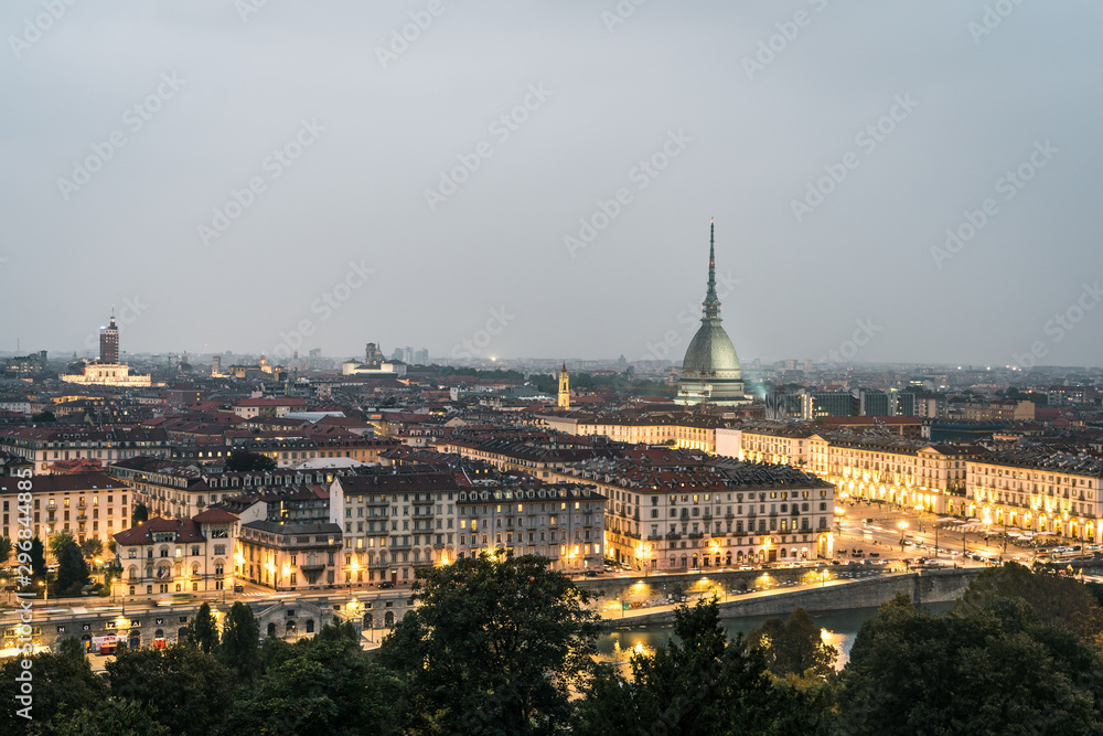 The city of Turin at sunset, great view of the Mole Antonelliana when the city  lightning up