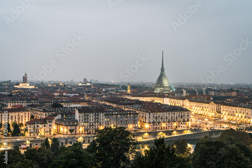 The city of Turin at sunset, great view of the Mole Antonelliana when the city lightning up