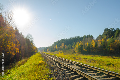  railway track in the autumn forest.  railway in the autumn evening