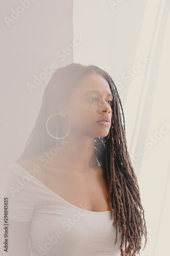 Woman with long dreadlocks and hoop earrings