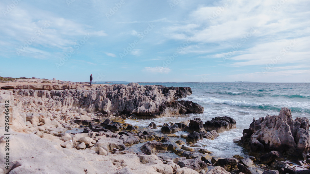 Man standing on sea rock Man standing on sea rock