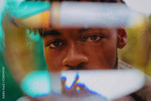 Man looking through prism
