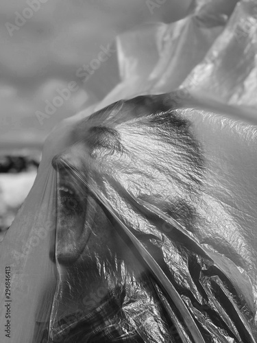 Man in plastic cover opens his mouth wide