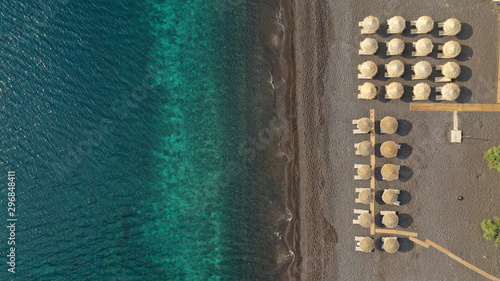 Aerial drone top down photo of organised Mediterranean sandy beach with sand beds and umbrellas