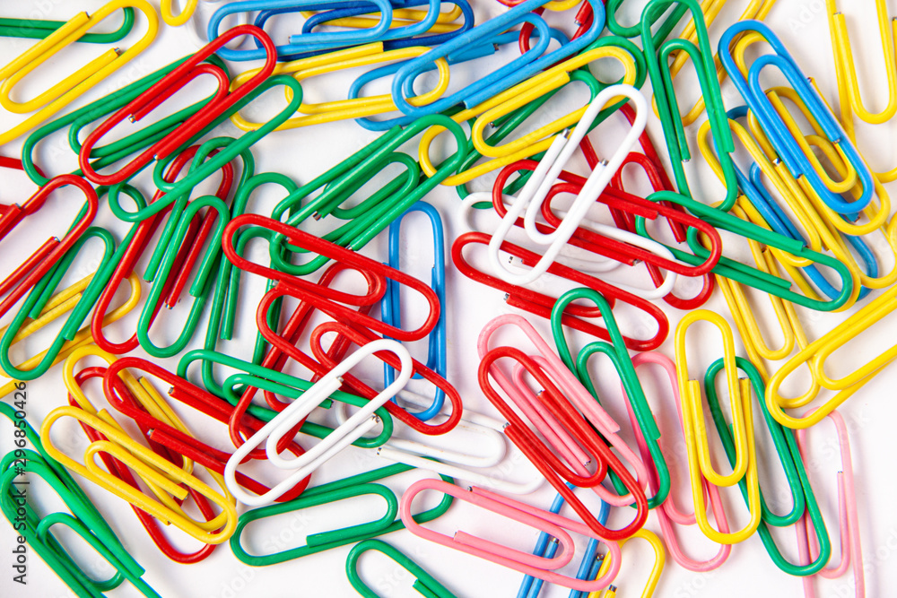 Top view of many colorful paper clips coated in a mix of plastic and rubber. Office concept Top view of many colorful paper clips coated in a mix of plastic and rubber. Office concept