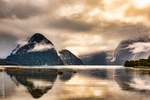 Magical crystal clear reflections at Milford Sound on a stormy rainy day