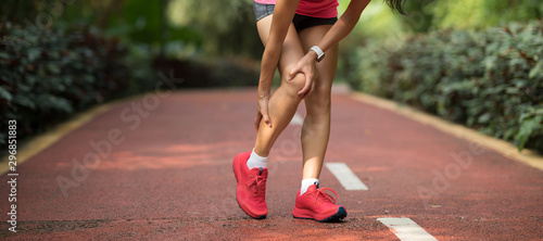 Female runner suffering with sports injury on running