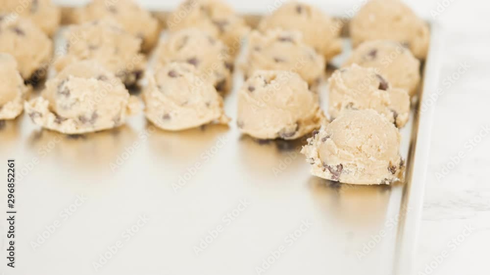 Step by step. Scooping homemade chocolate chip cookies with metal dough scoop to the baking sheet. Step by step. Scooping homemade chocolate chip cookies with metal dough scoop to the baking sheet.