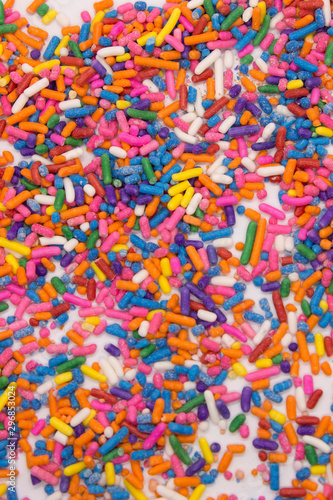 This is a photograph of colorful sprinkles isolated on a White background © dana_zurki
