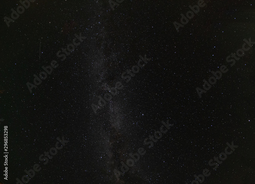 Milky Way galaxy and distant shooting star in the star-filled night sky
