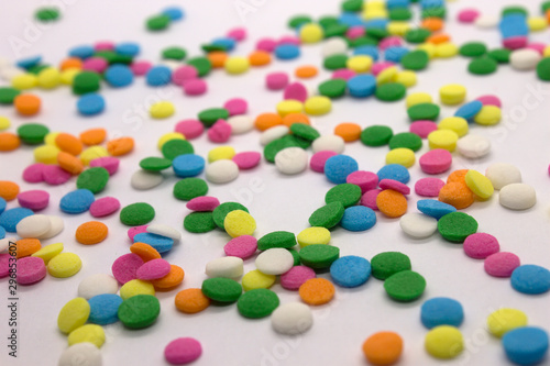 This is a photograph of colorful round sprinkles isolated on a White Background