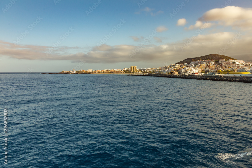 Los Cristianos - Las Americas, Tenerife, Spain - May 25, 2019: View to the coastline from the ferry departing for the island of La Gomera early morning from the port of Los Cristianos