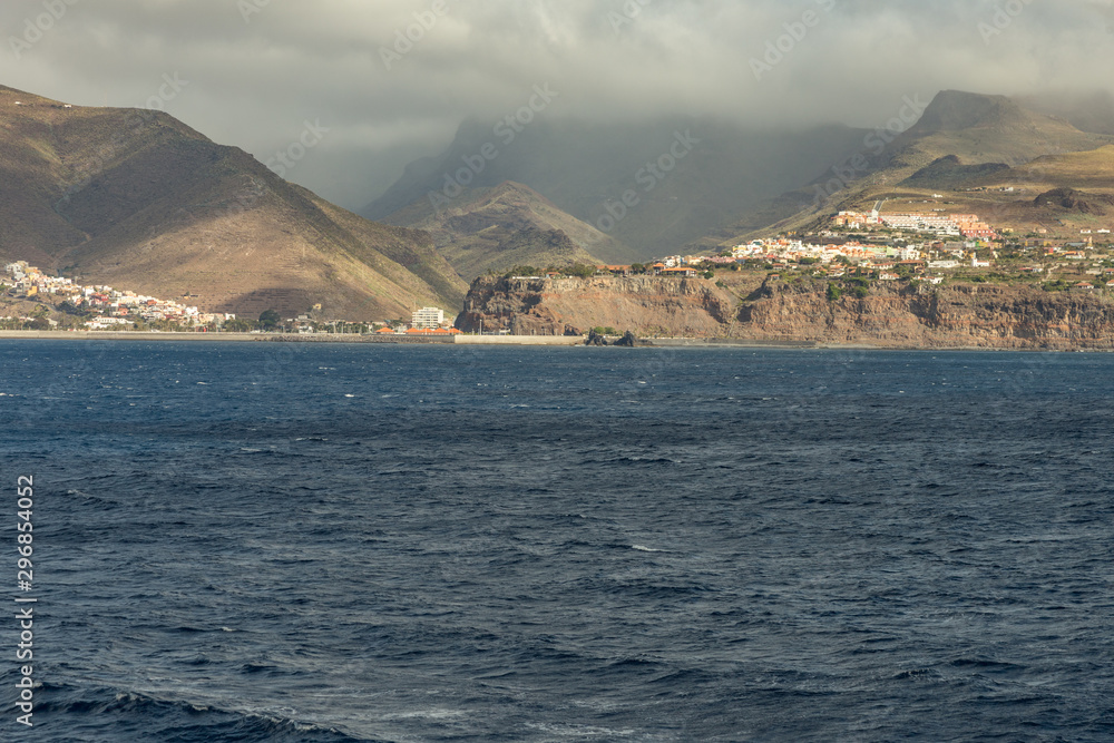 Port and town San Sebastian - capital of La Gomera Island. View from the ferry cruising between the islands of Tenerife and La Gomera. Canary Islands, Spain