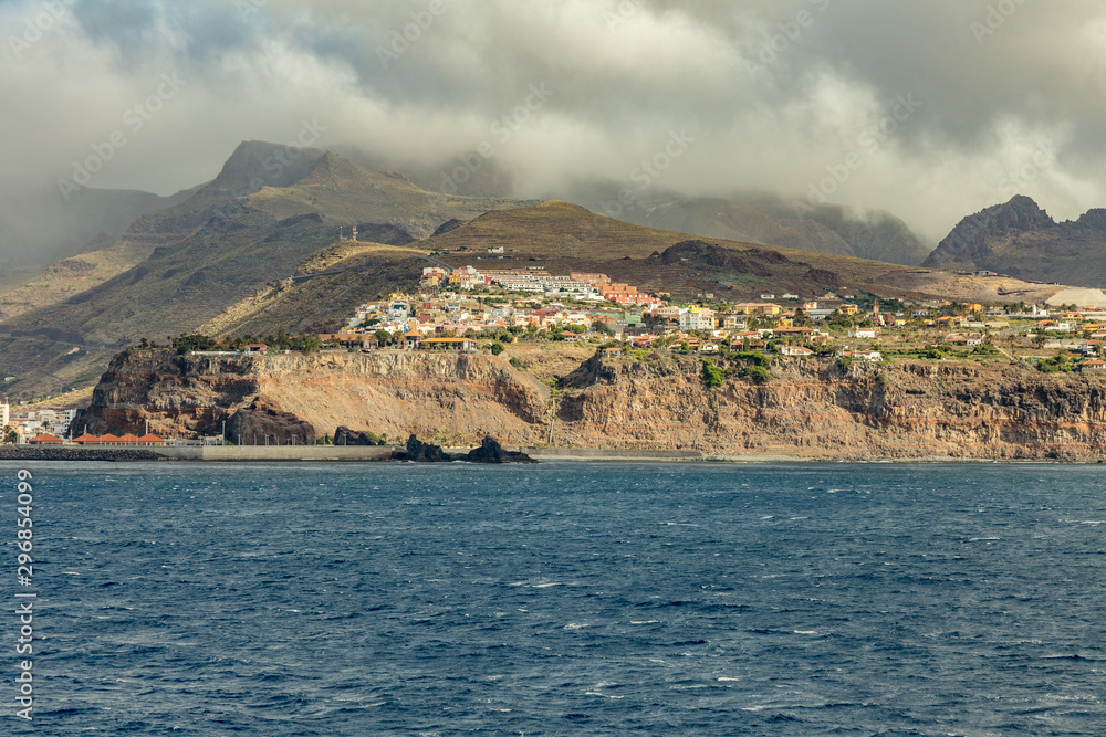Port and town San Sebastian - capital of La Gomera Island. View from the ferry cruising between the islands of Tenerife and La Gomera. Canary Islands, Spain