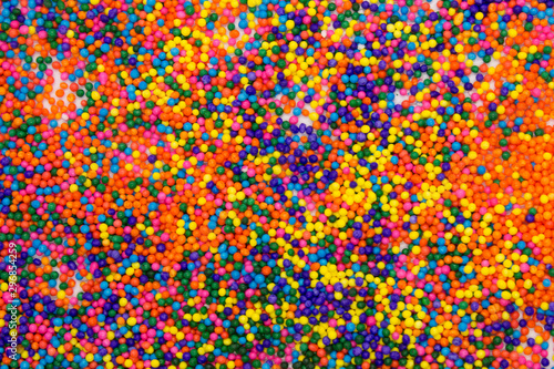 This is a background of colorful neon colored round sprinkles background