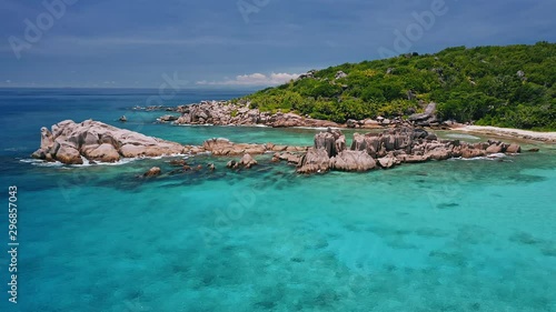 Aerial view of unique coastline with nature granite boulders on remote paradise like beach hidden in jungle. La Digue island, Seychelles photo