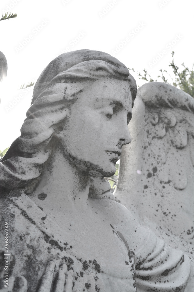 Sad angel as a symbol of eternity, life, death and afterlife. Vintage image of a sad angel in a cemetery. Angel and guardian.
