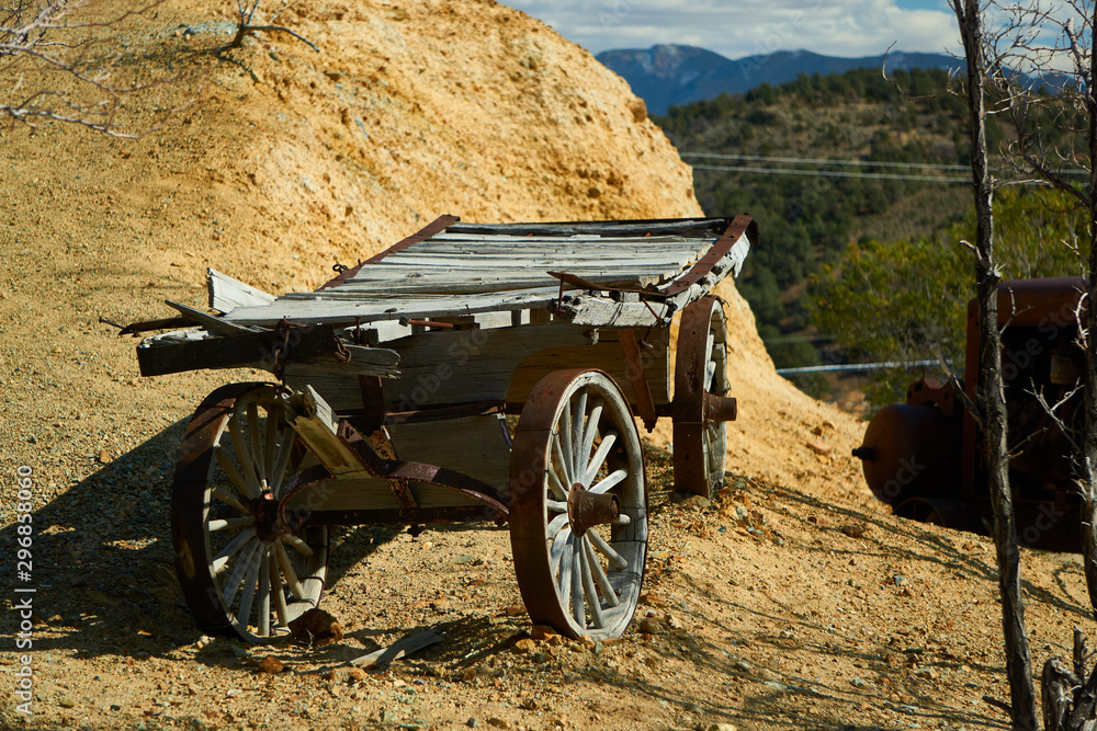 Well used wood wagon sits along side a pile of dirt and rock in Virginia City, Nevada