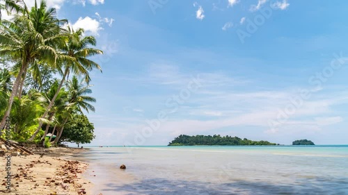 Time lapse Small tropical island With the day when the waves are calm Sandy beach with coconut trees. photo