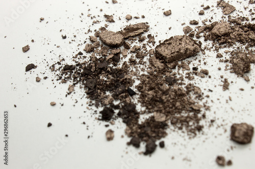 This is a photograph of a light Brown powder eyeshadow isolated on a White background