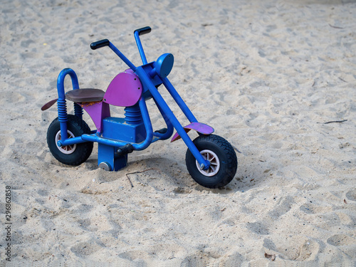 Chopper motorbike on the sand, waiting for children playing in the playground