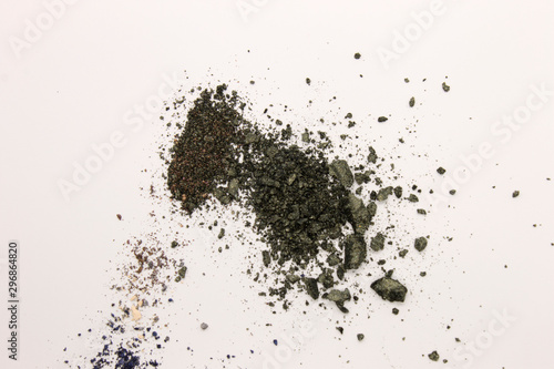 This is a photograph of Olive Green powder Eyeshadow isolated on a White background