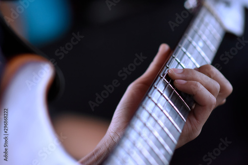 hand over guitar and playing