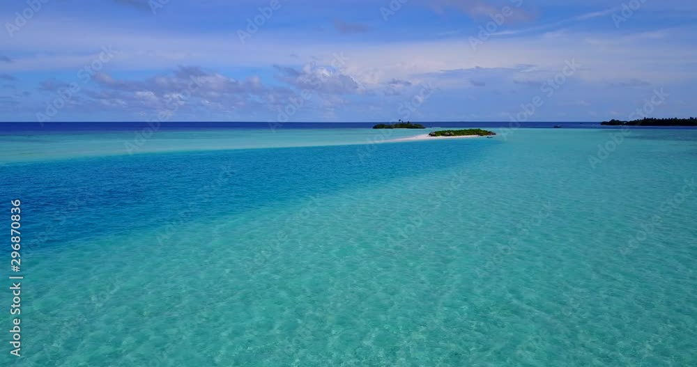 Aerial pan view around a group of tiny tropical islands in the middle of turquoise water of Indian ocean Aerial pan view around a group of tiny tropical islands in the middle of turquoise water of Indian ocean