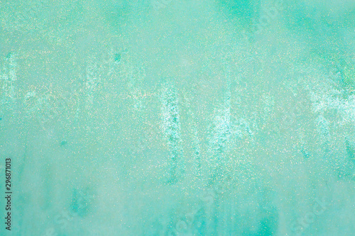 This is a photograph of a Turquoise shiny lip gloss swatch background