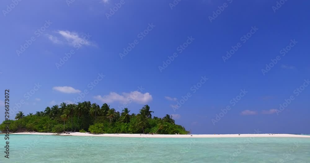 Violet blue sky over an isolated tropical island with a white stripe beach in Grenada, Caribbean Violet blue sky over an isolated tropical island with a white stripe beach in Grenada, Caribbean