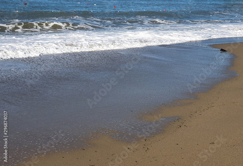 Surf the waves foaming on the shore of the Mediterranean sea. Natural phenomenon. Travel to the sea for relaxation