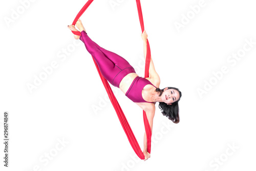 Beautiful woman Asian sport girl fly yoga posing on a red hammock isolated white background , Aerialist gymnastics performs physical exercises - yoga concept