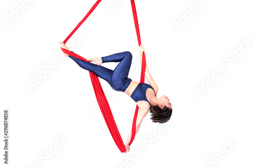 Beautiful woman Asian sport girl fly yoga posing on a red hammock isolated white background , Aerialist gymnastics performs physical exercises - yoga concept