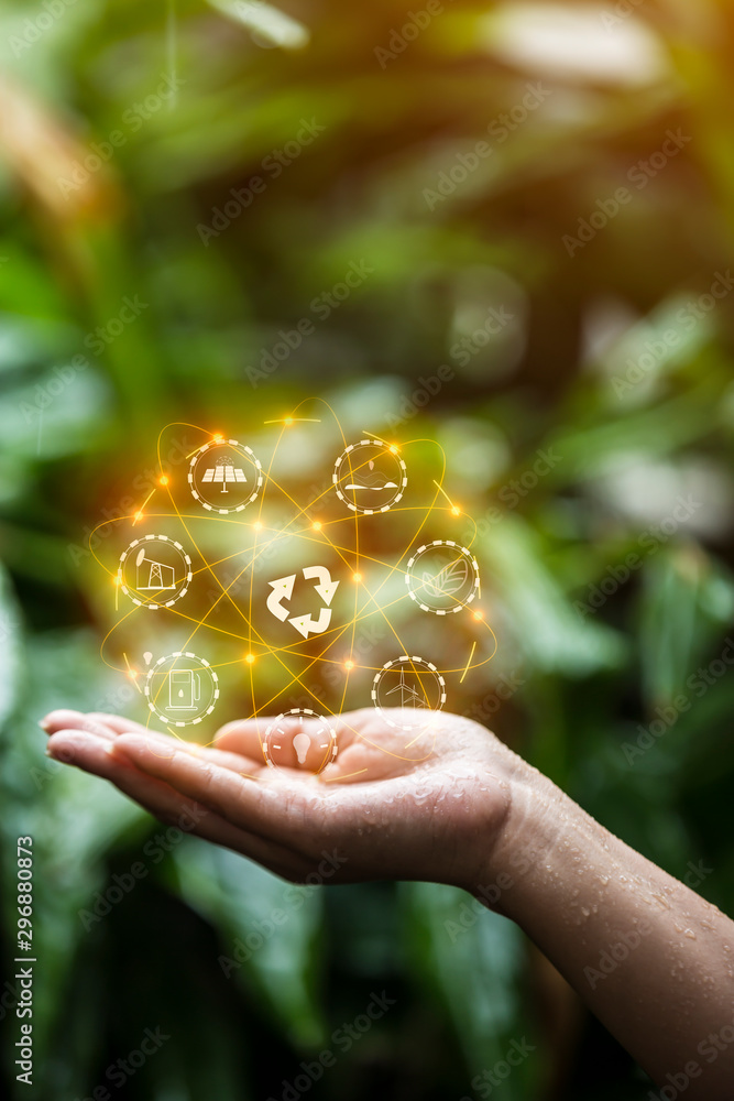 Technology, hand holding with environment Icons over the Network connection on green background. Technology, hand holding with environment Icons over the Network connection on green background.