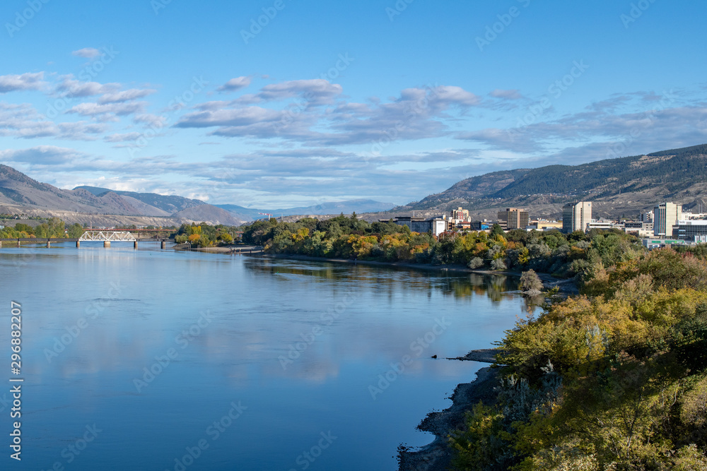 2019-10-03 Kamloops, BC, Canada. Riverside Park. View of Thompson River, Kamloops downtown buildings, mountains, trees.