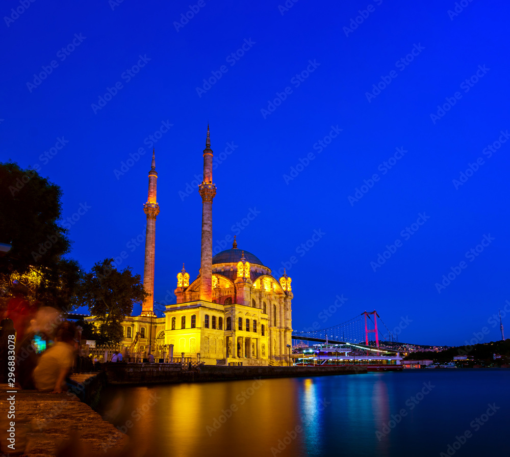 Ortakoy mosque and the bosphorus bridge at night in Istanbul, Turkey.