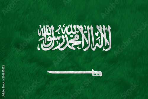 Towel fabric pattern flag of Saudi Arabia, a green field with the Shahada or Muslim creed written in the Thuluth script in white above a horizontal saber.