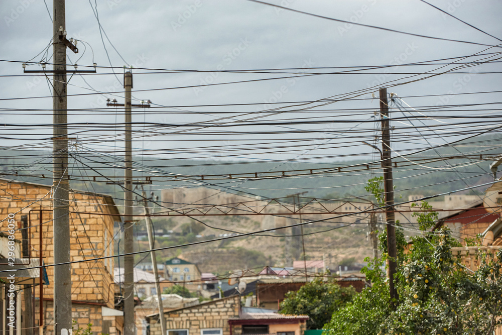 Power line post with electrical wires and capacitors isolated on blue sky background. Electricity transmission line, power supply Power line post with electrical wires and capacitors isolated on blue sky background. Electricity transmission line, power supply