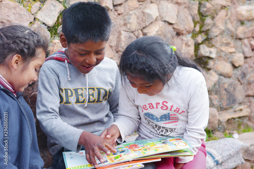 Native american kids reading a  book. photo