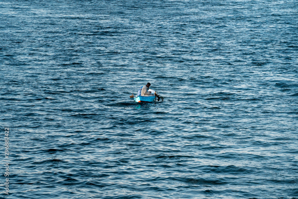 young man in a fishing boat