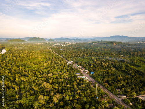 Aerial Landscape of Roads, travel routes in natural tourism in Thailand, paths cut through beautiful mountain forests And with the sky and sunshine as the background. © thatkasem14