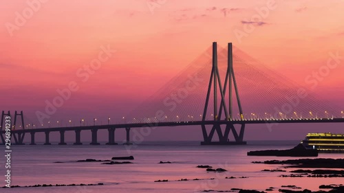 Zooming in Footage of the Iconic Bandra Worli Sea Link (BWSL) Bridge also known as Rajiv Gandhi Sea Link, after sunset, Mumbai, Maharashtra, India. photo