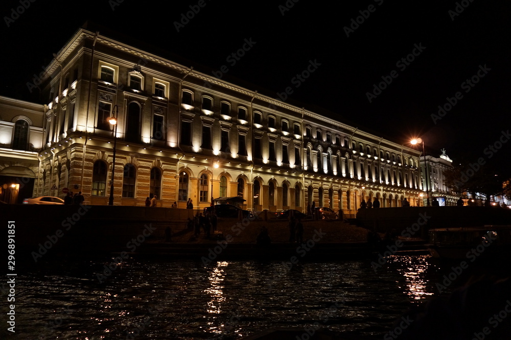 a building from a river at night