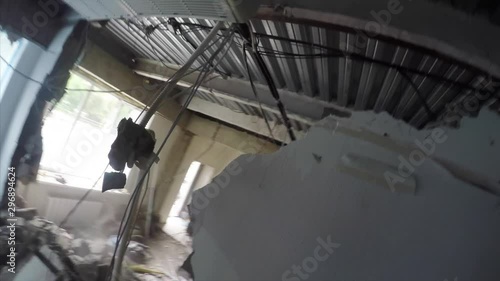 First person view of demolition work. A man is destroying a wall using hammer photo