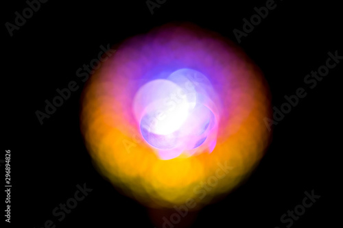Abstract round blurred bokeh red yellow blue ball on a black background.