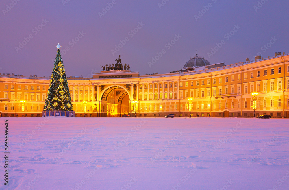 St. Petersburg in the New Year holidays. View of the snowy Palace Square with a decorated Christmas tree and the General Staff building in the evening