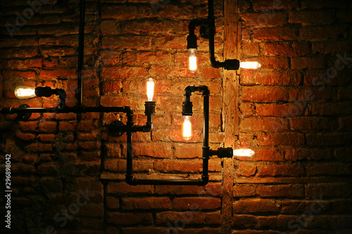 Edison Lamp and copper tubes on the dark background in the cafe in Tbilisi Georgia on October 2019.