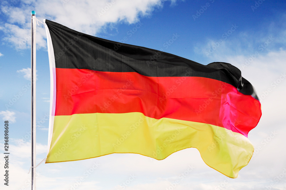 Germany flag waving under blue sky Germany flag waving under blue sky