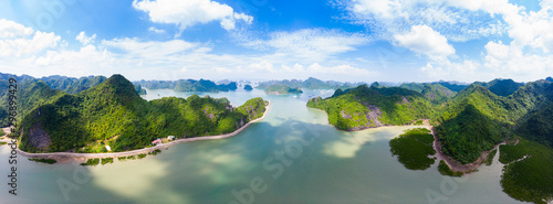 Aerial view of Ha Long from Bay Cat Ba island, unique limestone rock islands and karst formation peaks in the sea, famous tourism destination in Vietnam. Scenic blue sky.