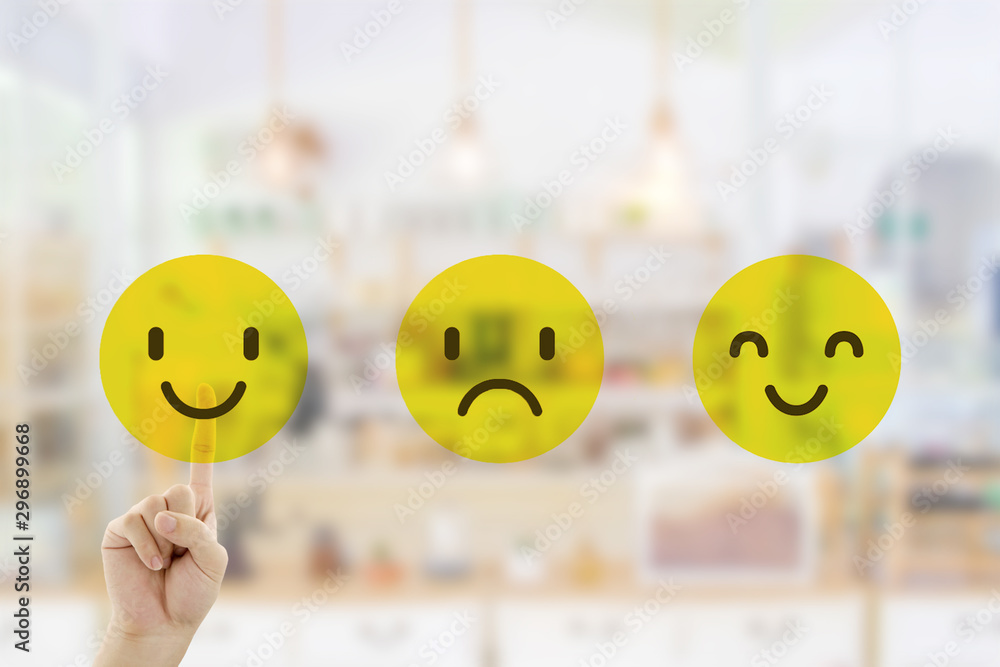 Customer Feedback Concept : Hand pressing smile emotion icons for giving best service ranking with blurred front view of cafe restaurant or coffee shop in the hotel. Customer Feedback Concept : Hand pressing smile emotion icons for giving best service ranking with blurred front view of cafe restaurant or coffee shop in the hotel.